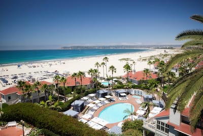 Overhead view of pool with loungers, and beach in background