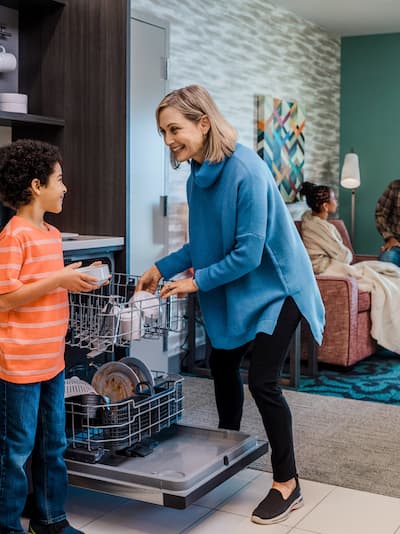 A family in a Home2 Suites two-room suite.
